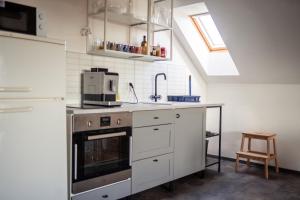 a kitchen with a sink and a stove at Apartmán 7J in Hnanice +6 photos