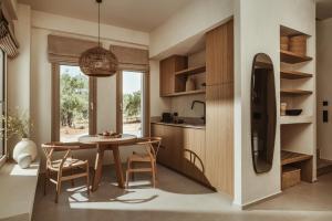 a kitchen with a table and chairs in a room at Levante Afitos Suites - Adults Only in Afitos