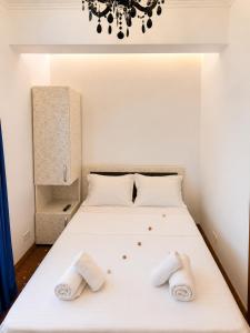 a bedroom with a bed with two towels on it at Villa Italia Boutique in Mamaia Sat/Năvodari