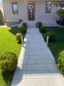 a walkway in front of a house with a door at Villa Italia Boutique in Mamaia Sat/Năvodari