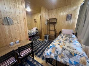 a room with two beds in a wooden room at Wooden house in Kutaisi