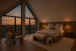 a bedroom with a large bed and a large window at De Duyn in Midsland +2 photos