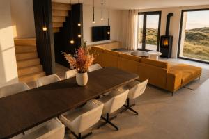 a living room with a table and a couch at De Duyn in Midsland
