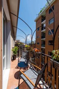 a balcony with chairs and tables on a building at Lumen Boutique Stay in Naples