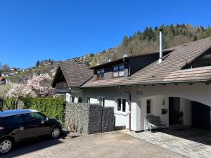 a car parked in front of a house at Stylish & modern Flat with large Sun Balcony in Bad Peterstal