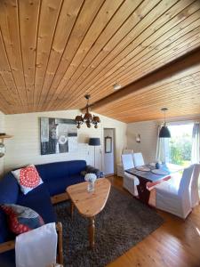 a living room with a blue couch and a table at Snøhetta Camping in Hjerkinn