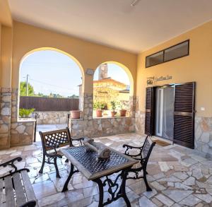 a patio with a table and chairs and a fireplace at Sweet Nonna Dora Corato - Casa con Parcheggio in Corato