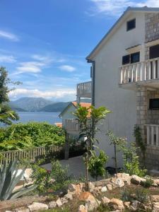 a white building with a view of the water at Pier Apartments in Krašići