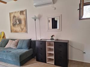 a living room with a couch and a dresser at Salatić-Lekić apartmani in Čanj