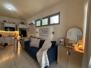 a living room with a blue couch and a kitchen at Villa Marelena Beachfront Villa Aguada Near Rincón in Tablonal