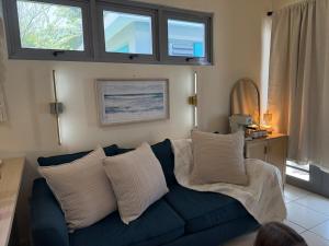 a blue couch with white pillows in a living room at Villa Marelena Beachfront Villa Aguada Near Rincón in Tablonal
