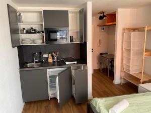 a small kitchen with a sink and a counter at Apartment Altstadt Stralsund in Stralsund