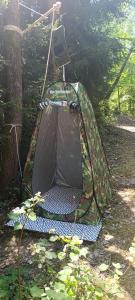 a tent hanging from a tree in the woods at Maringotka pod hvozdem in Spešov +10 photos