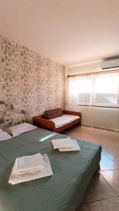 a bedroom with two beds with towels on them at Anavyssos Serenity Villa in Anavyssos