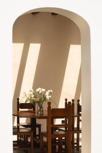 a table with a vase of flowers on it at Casa Olivi in Ventotene +25 photos