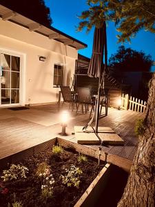a patio with an umbrella and a table and chairs at Joachims Ruhe in Joachimsthal