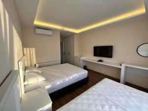 a hotel room with two beds and a flat screen tv at Dada Otel in Ezine