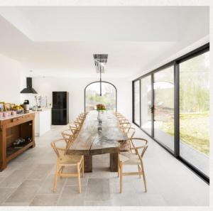 a dining room with a large wooden table and chairs at Villa Cdv in Ellezelles