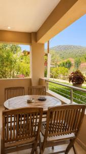 a table and two chairs on a balcony with a view at Studios Galini Porto Koufo in Porto Koufo