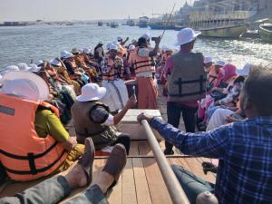 a group of people on a boat in the water at KHS ROOMs near ghat and temples in Varanasi +30 photos