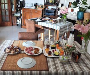 a table with plates of food on it in a kitchen at Sandra B&B in Luz de Tavira