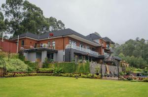 a large house with a lawn in front of it at Sharuu Residency in Msaranga
