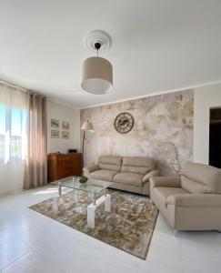 a living room with a couch and a table at La Lidia in Sassari