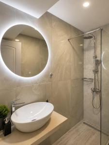 a bathroom with a white sink and a mirror at Studios Prodromidis Πρεβεζα in Preveza +22 photos