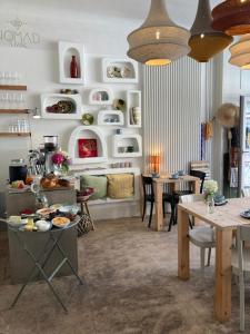 a living room with tables and chairs and a dining room at Flusshaus BnB Okavango in Brugg