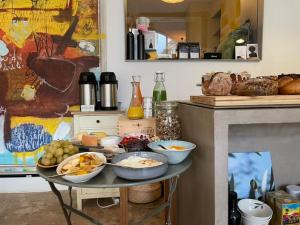 a table with bowls of food on it in a kitchen at Flusshaus BnB Okavango in Brugg