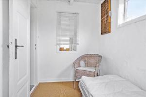 a white room with a chair and a window at 30001-Malling-Hasselvaenget-7 in Malling