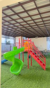 a play room with a playground with a slide at استراحة الوداد in Qurayyah