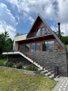 a brick house with a staircase in front of it at A-frame Noa Cabin in Teşila