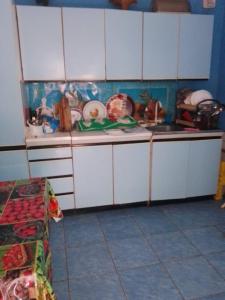 a kitchen with white cabinets and a counter top at Кооператив Радуга in Rasseyka