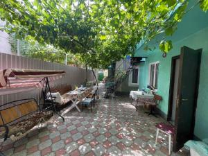 a patio with tables and chairs and a building at Кооператив Радуга in Rasseyka