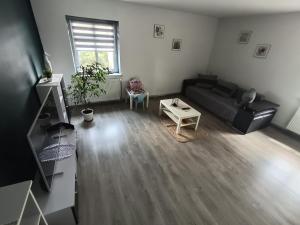 a living room with a couch and a table at Ewula in Giżycko