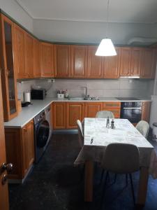 a kitchen with a table with chairs and a sink at Lamia House in Lamía