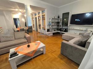 a living room with two couches and a table at Lamia House in Lamía