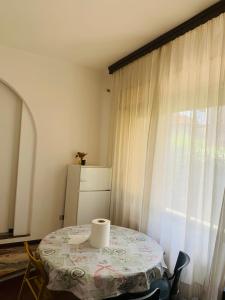 a room with a table and a window with a curtain at Venice Villa House in Mestre