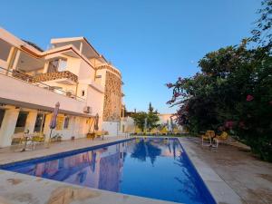 a swimming pool in front of a house at NN Residence Tabarka in Tabarka