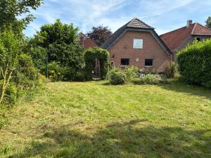 an old brick house with a yard at Modernes Landhaus Modern country house in Kalkar