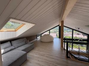 a living room with a couch and a window at Chalet du paradis in La Bresse +9 photos