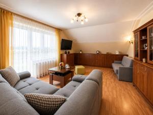 a living room with a couch and a table at Admiral aqua resort in Mielno