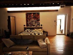 a living room with a couch and a bed at Phreude Loft in Aschach an der Donau