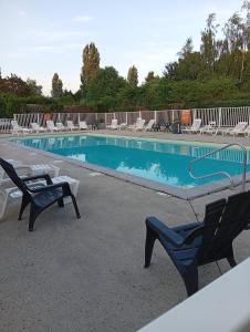a swimming pool with lounge chairs and a swimming pool at ZEN cocoon in Ivry-la-Bataille