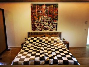 a bedroom with a checkered bed and a painting on the wall at Phreude Loft in Aschach an der Donau +16 photos