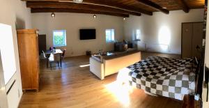 a bedroom with a bed and a desk and a tv at Phreude Loft in Aschach an der Donau