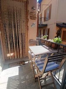 a table and chairs sitting on a balcony at The Lake Chime in Colonno