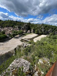 a view of a river with a town in the background at Chamalobri in Labeaume +8 photos