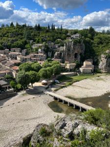 a view of a town with a bridge over a river at Chamalobri in Labeaume